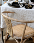 wicker backed dining chairs at table.