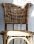 wicker dining chairs in the sunlight.