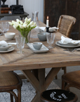 Reclaimed Wood Dining Table with tulips and a candle.