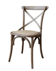 White washed wooden dining chair with wicker seat.