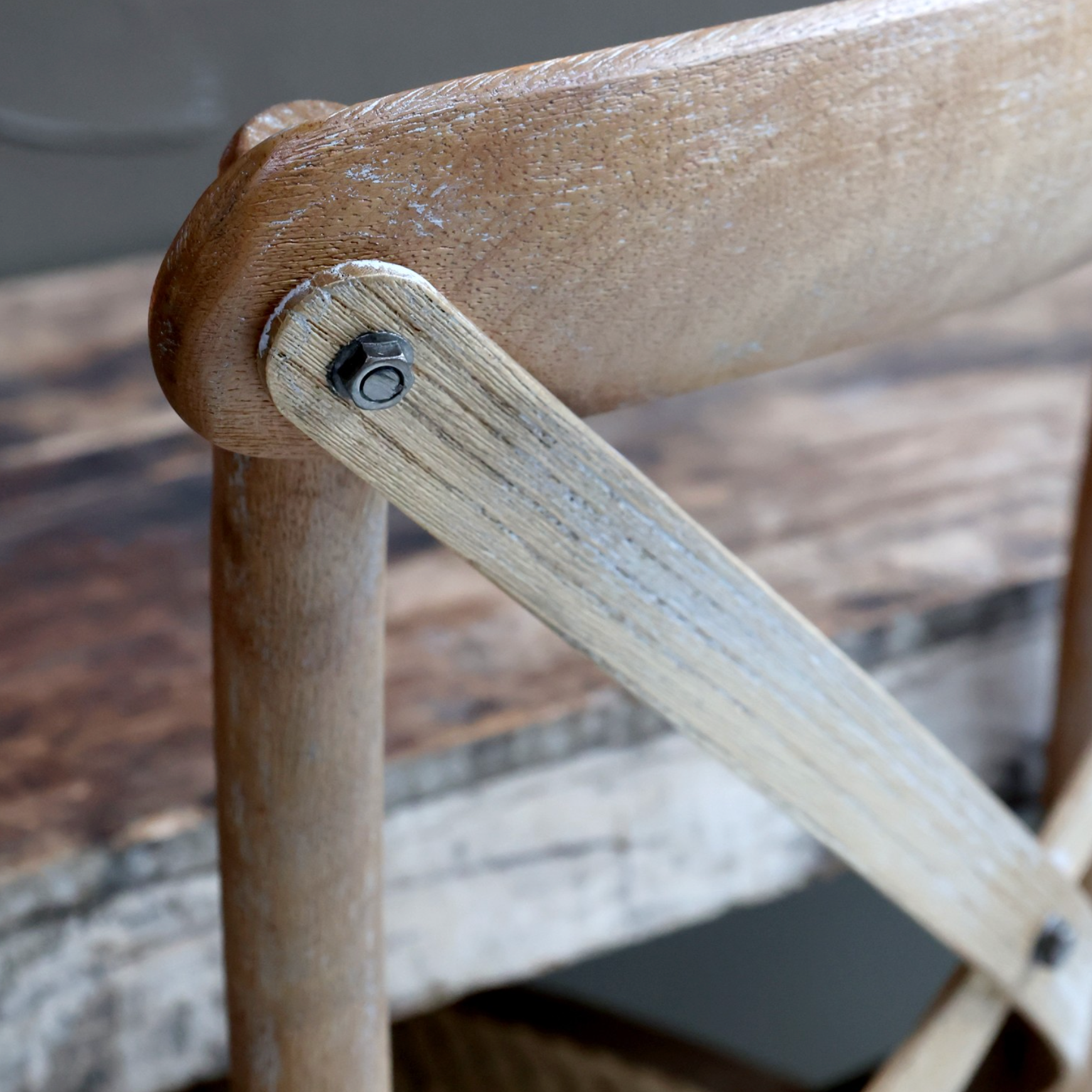 A close up image of the back of a wooden dining chair.