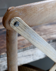 A close up image of the back of a wooden dining chair.