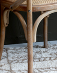 a close up image of the legs on a wooden dining chair.