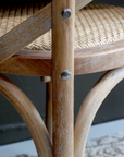 A close up image of a dining chair with wicker seat.