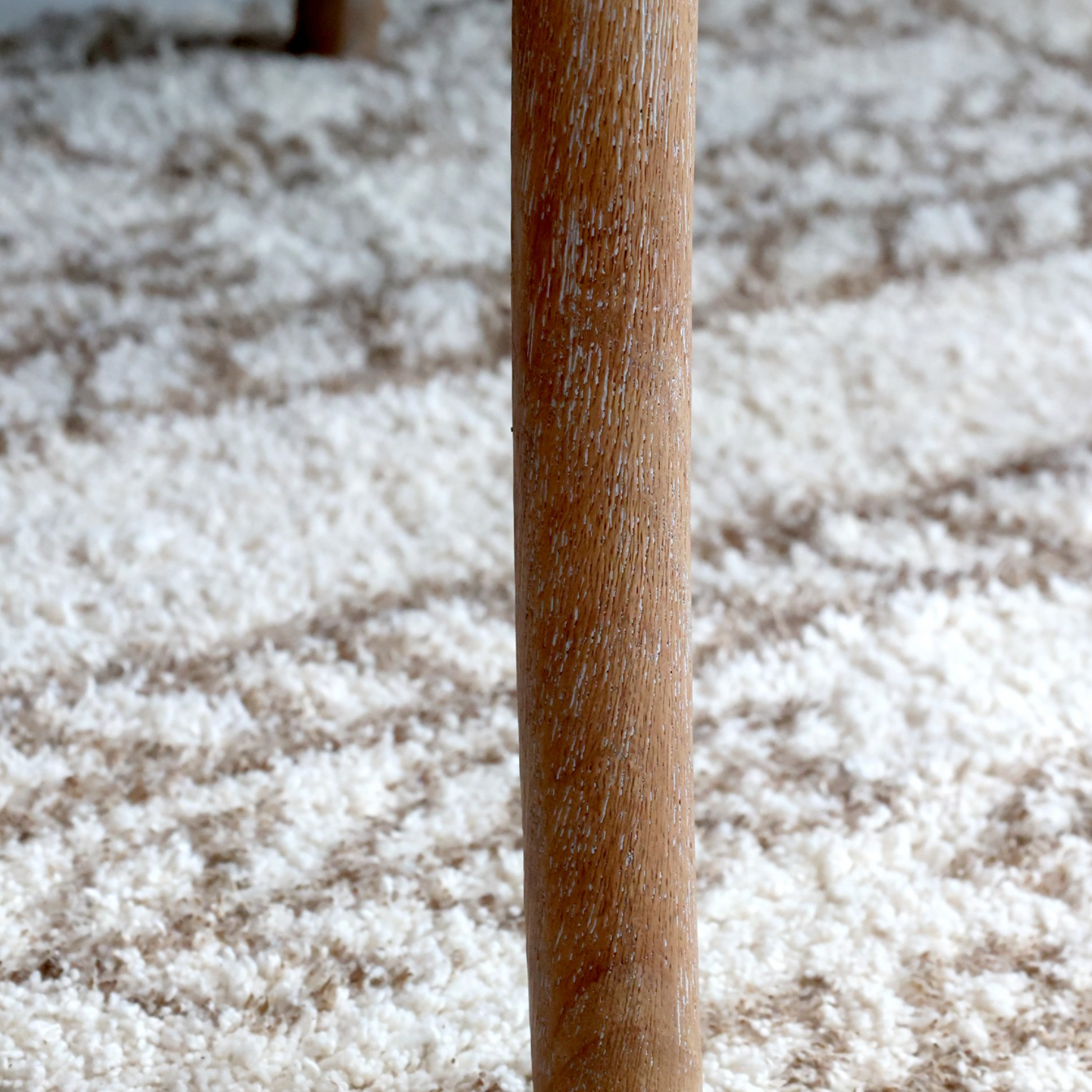 A close up image of a wooden dining chair's leg.