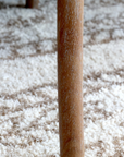 A close up image of a wooden dining chair's leg.