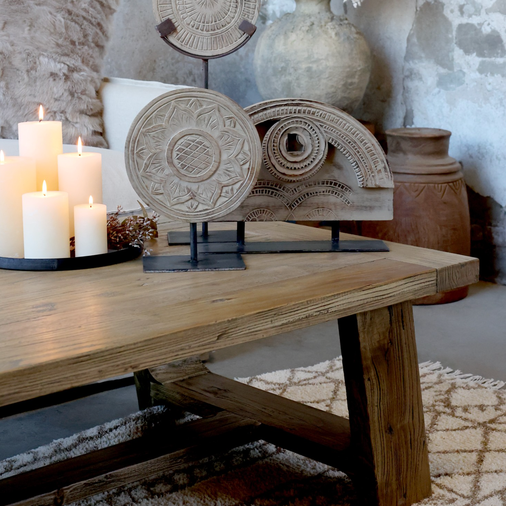 rustic wooden coffee table with decor items and candles.