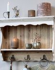 Rustic white wooden wall shelf with decor items.