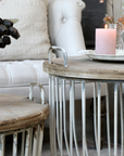 a close up of our rustic coffee tables set with pink decor.