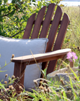 wooden outdoor armchair with white cushion.