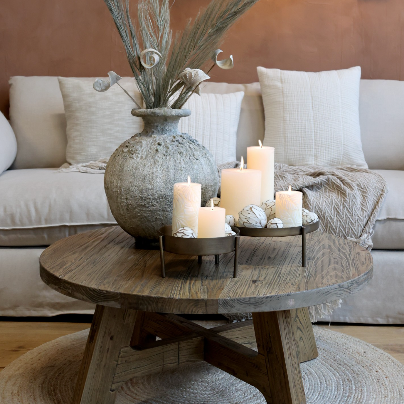 Round Wooden Coffee Table with rustic vase and candles