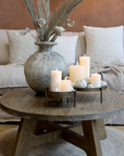 Round Wooden Coffee Table with rustic vase and candles