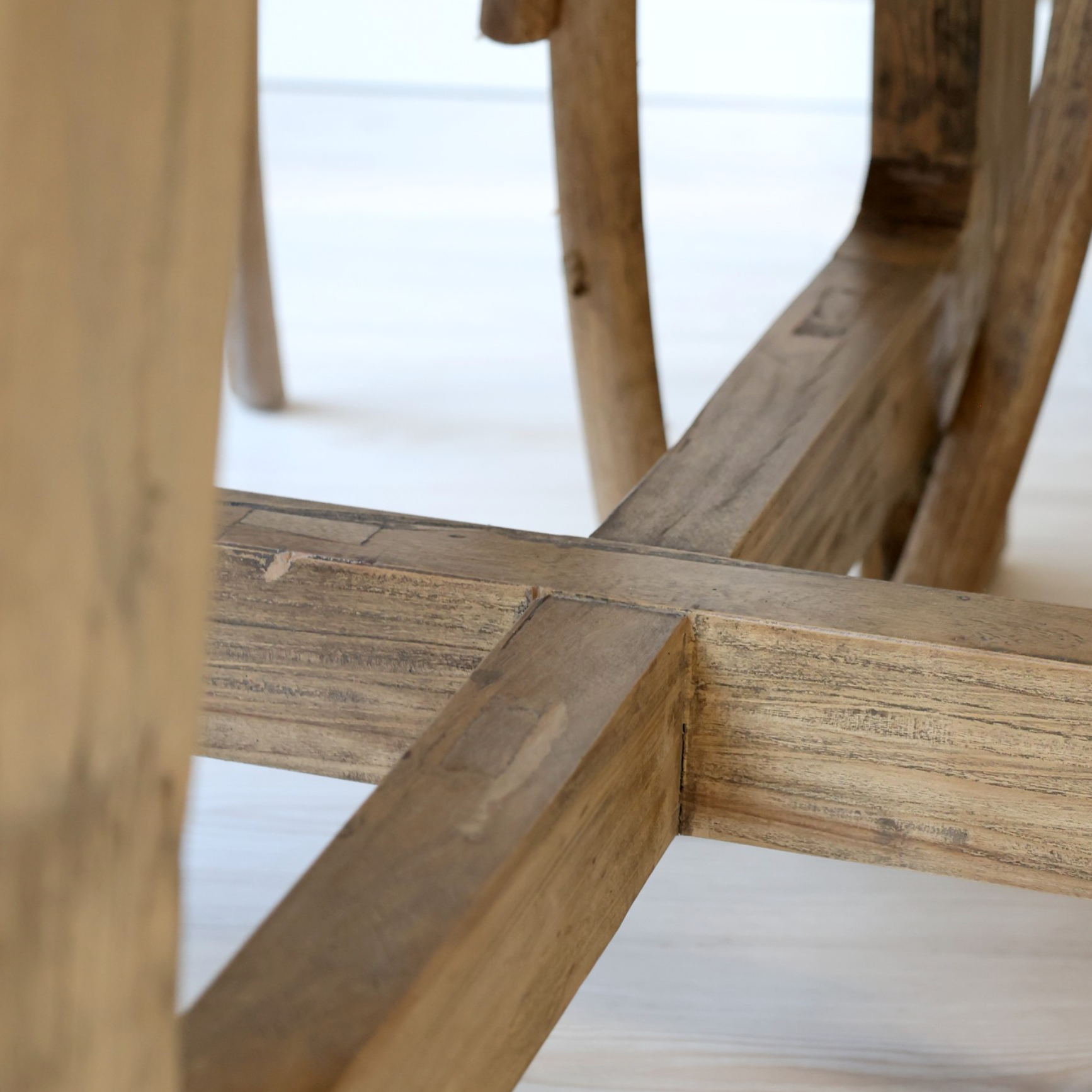 A close up of the underside of a Round wood dining table.