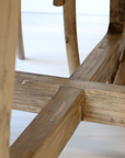 A close up of the underside of a Round wood dining table.