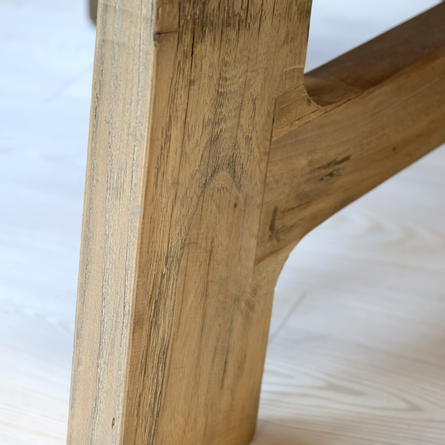 A close up of a wooden table leg.