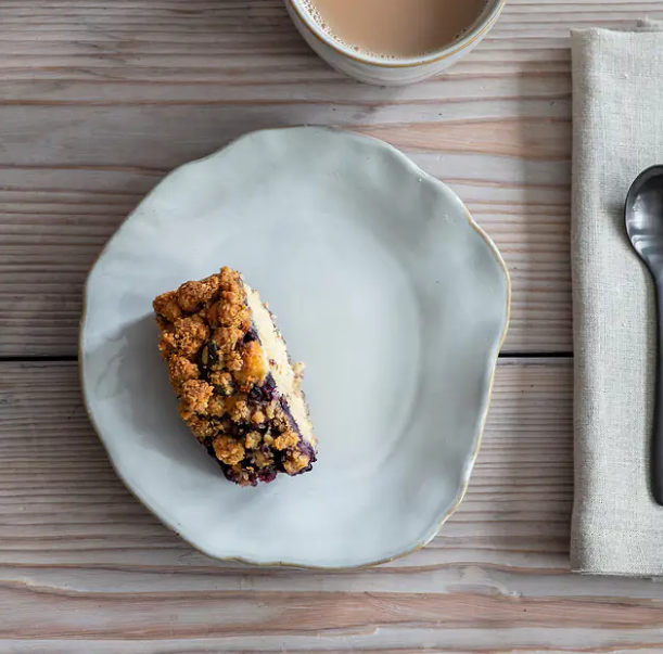 Organic white side plates with piece of cake on.