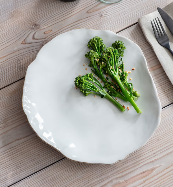 Organic white dinner plates with broccoli on.