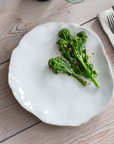 Organic white dinner plates with broccoli on.