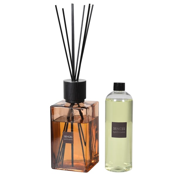 Amber reed diffuser with reed diffuser refill bottle with brown label.