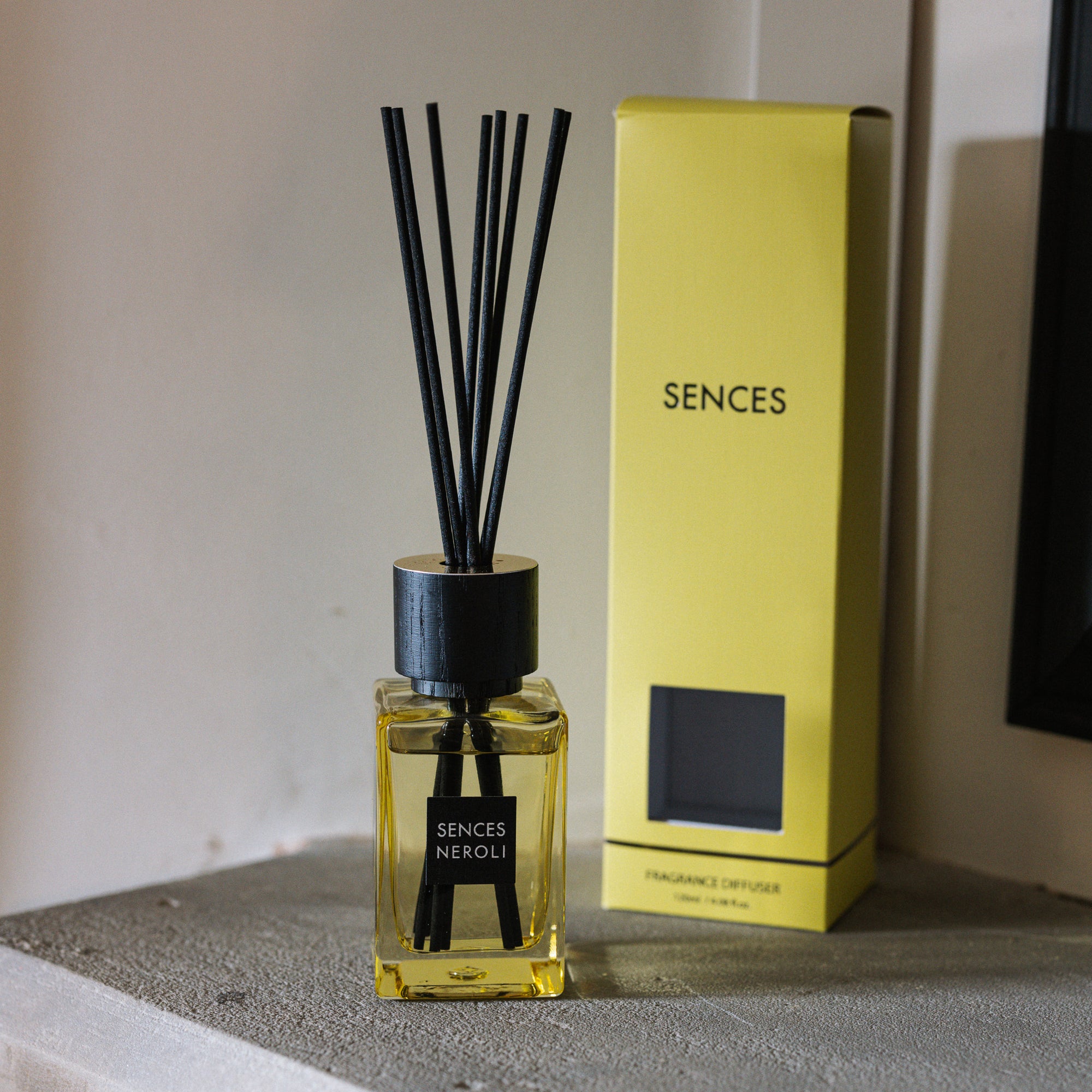 Sences Neroli Mini Reed Diffuser with gift box on stone mantle.