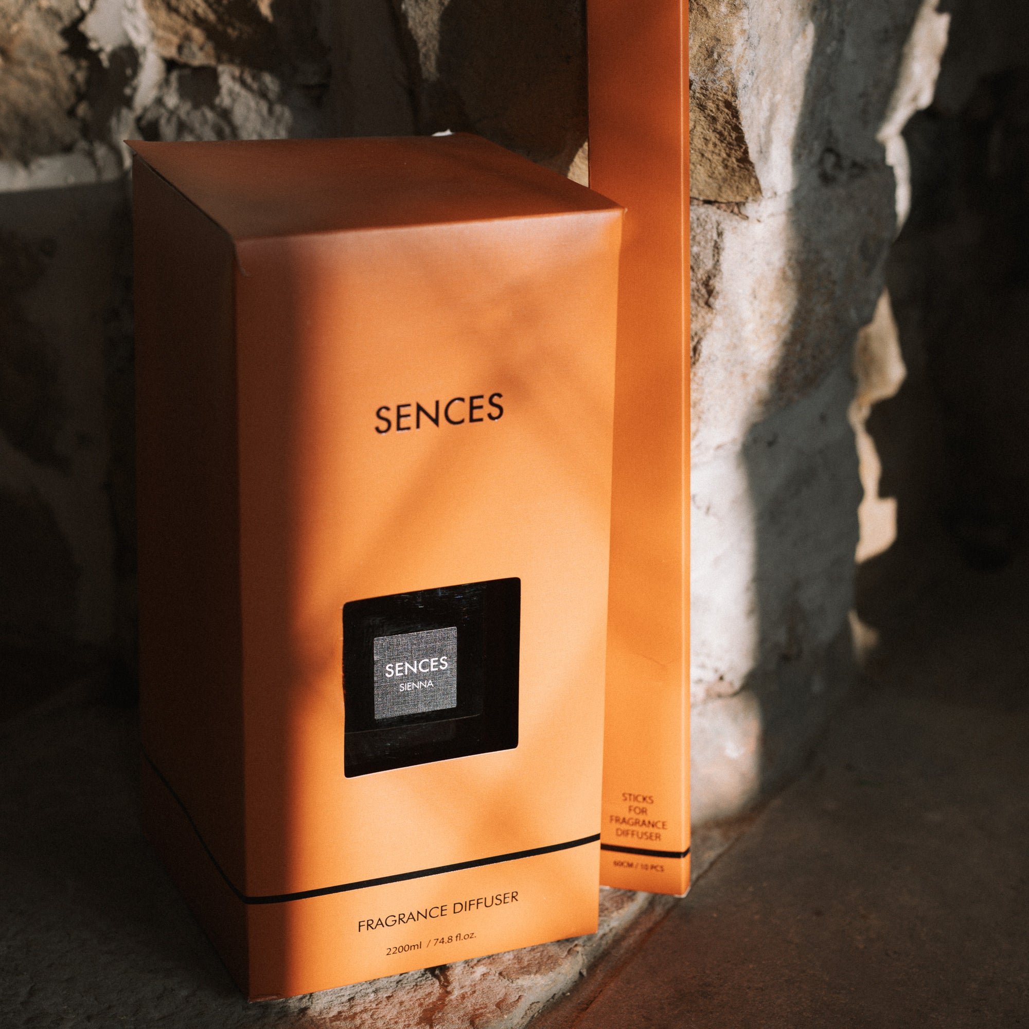 orange presentation box for large Sences diffuser on stone hearth.