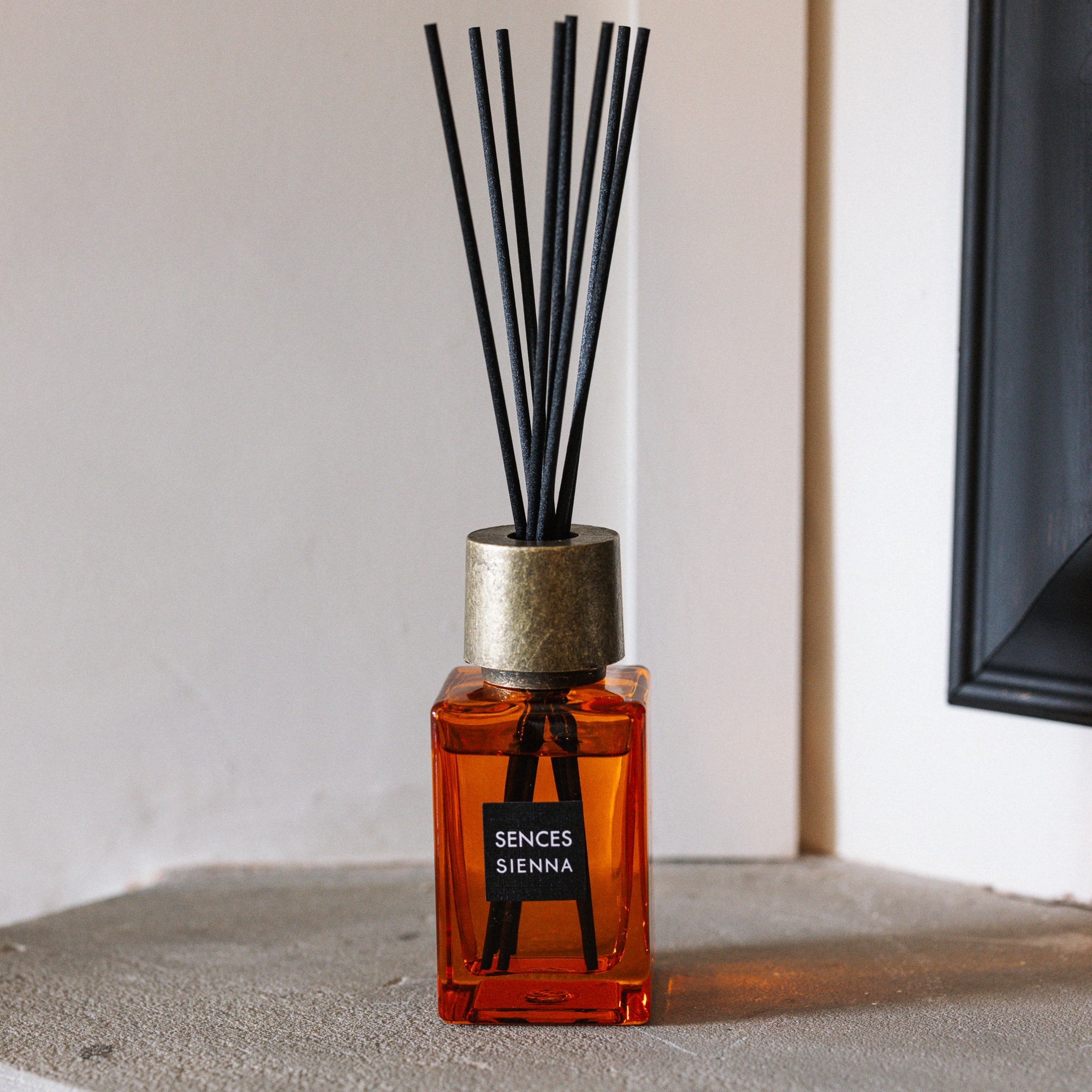 Sences Sienna Mini Reed Diffuser on stone mantle.