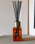 Sences Sienna Mini Reed Diffuser on stone mantle.