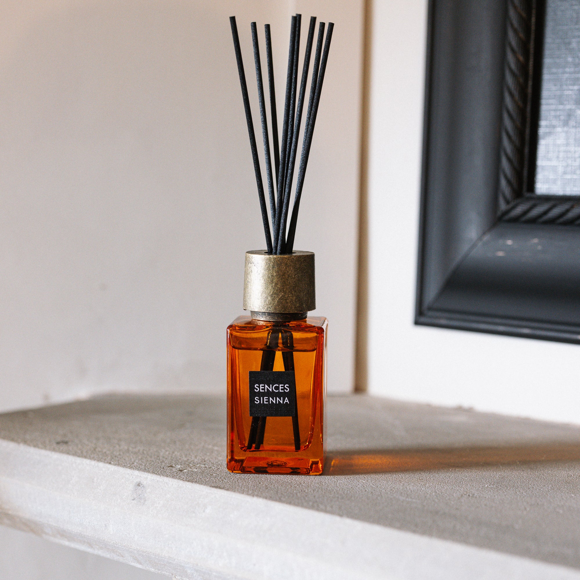 Sences Sienna Mini Reed Diffuser on stone mantle piece.