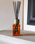 Sences Sienna Mini Reed Diffuser on stone mantle piece.