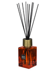 Sences Sienna Reed Diffuser in orange bottle against white background.