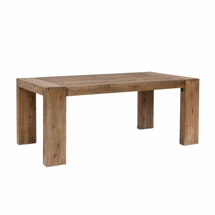 Solid chunky wood dining table on white background.