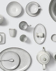 Off white speckle glazed full dinnerware collection.