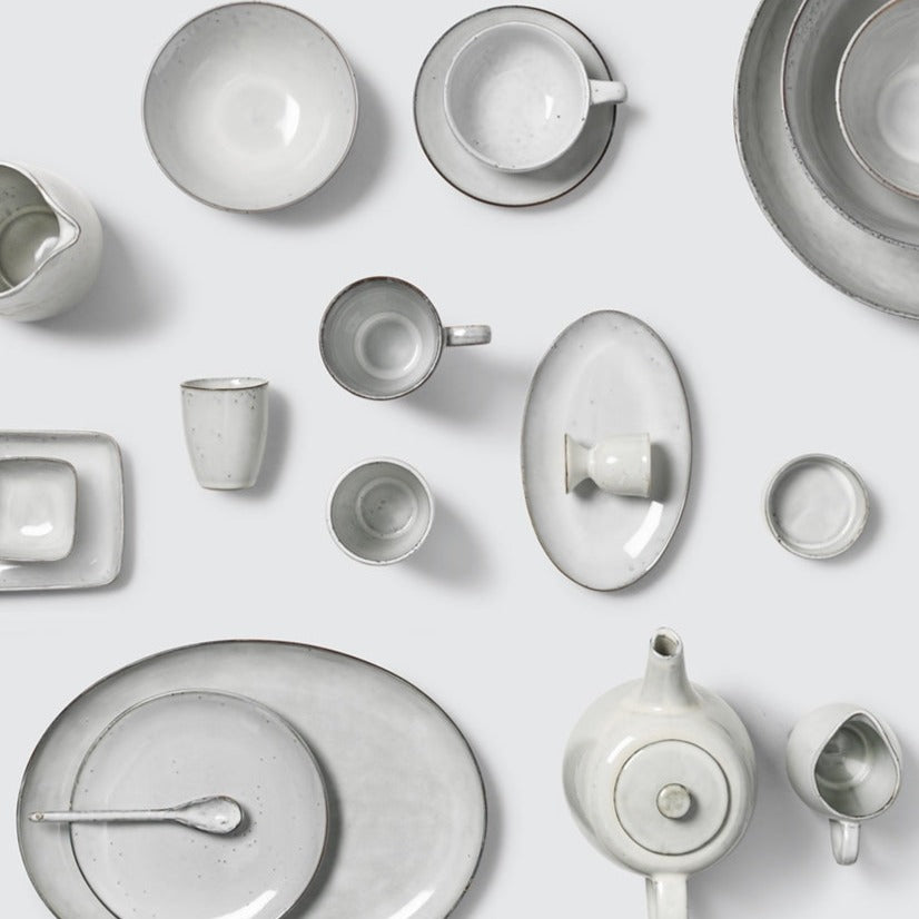 Full off white speckled dinnerware collection.