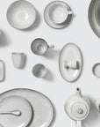 Full off white speckled dinnerware collection.