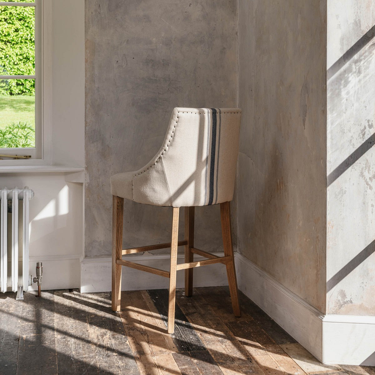  Upholstered Bar Stool With Back and blue stripe in neutral room.