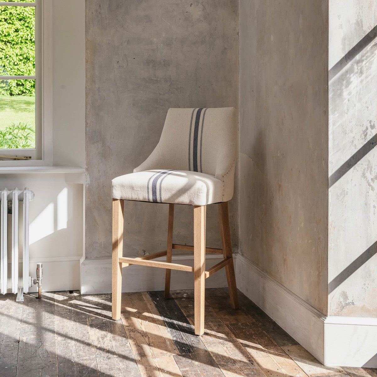 Upholstered Bar Stool With Back with blue ticking stripe in neutral room.