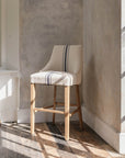 Upholstered Bar Stool With Back with blue ticking stripe in neutral room.