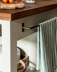 Close up of towel rail on wooden kitchen island.