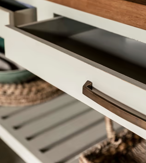 Close up of open drawer on wooden kitchen island.