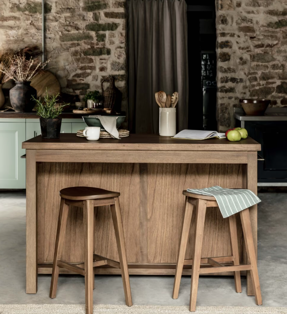 Wooden kitchen island with two bar stools and accessories