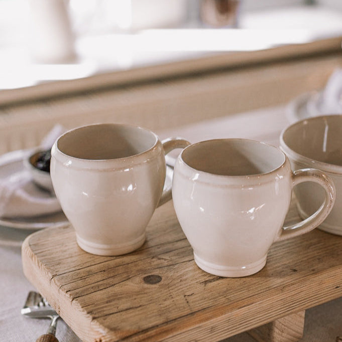 Set of two White Mugs on wooden serving plank.