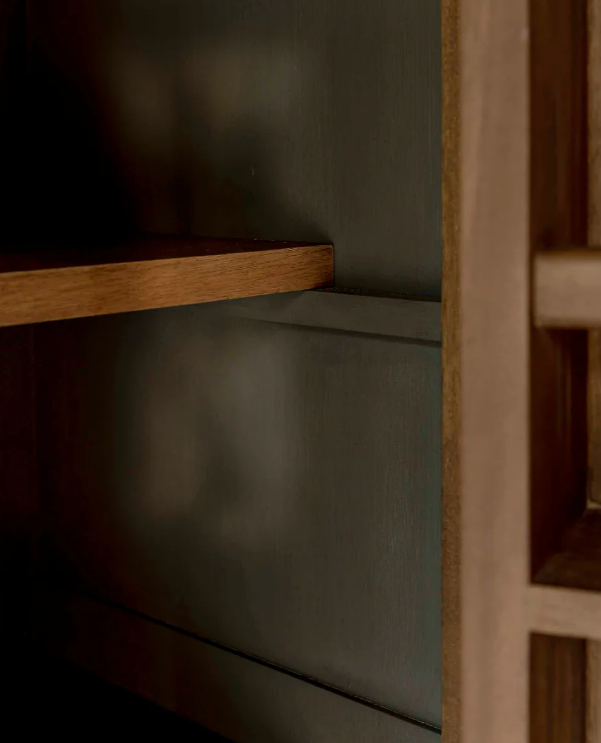 Close up of wooden shelf in pantry cupboard.