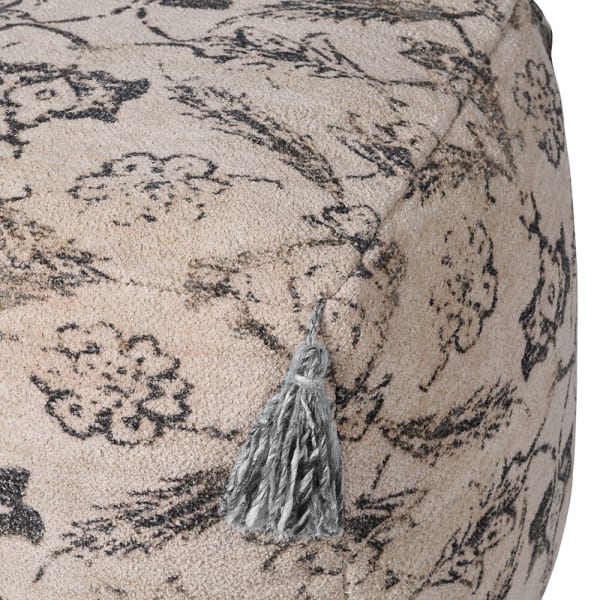 Close up of grey tassels on vintage patterned pouf.