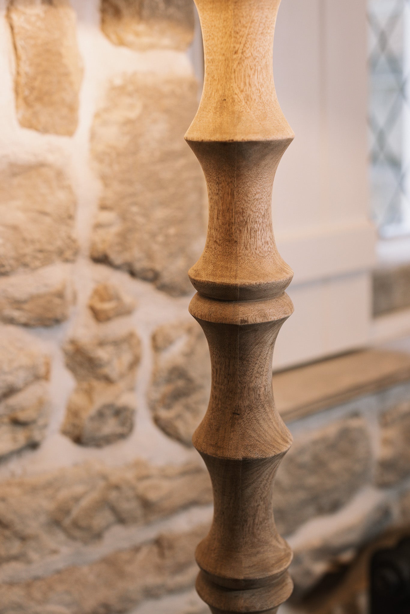 Detailed shot of Bamboo look wooden floor against stone wall.