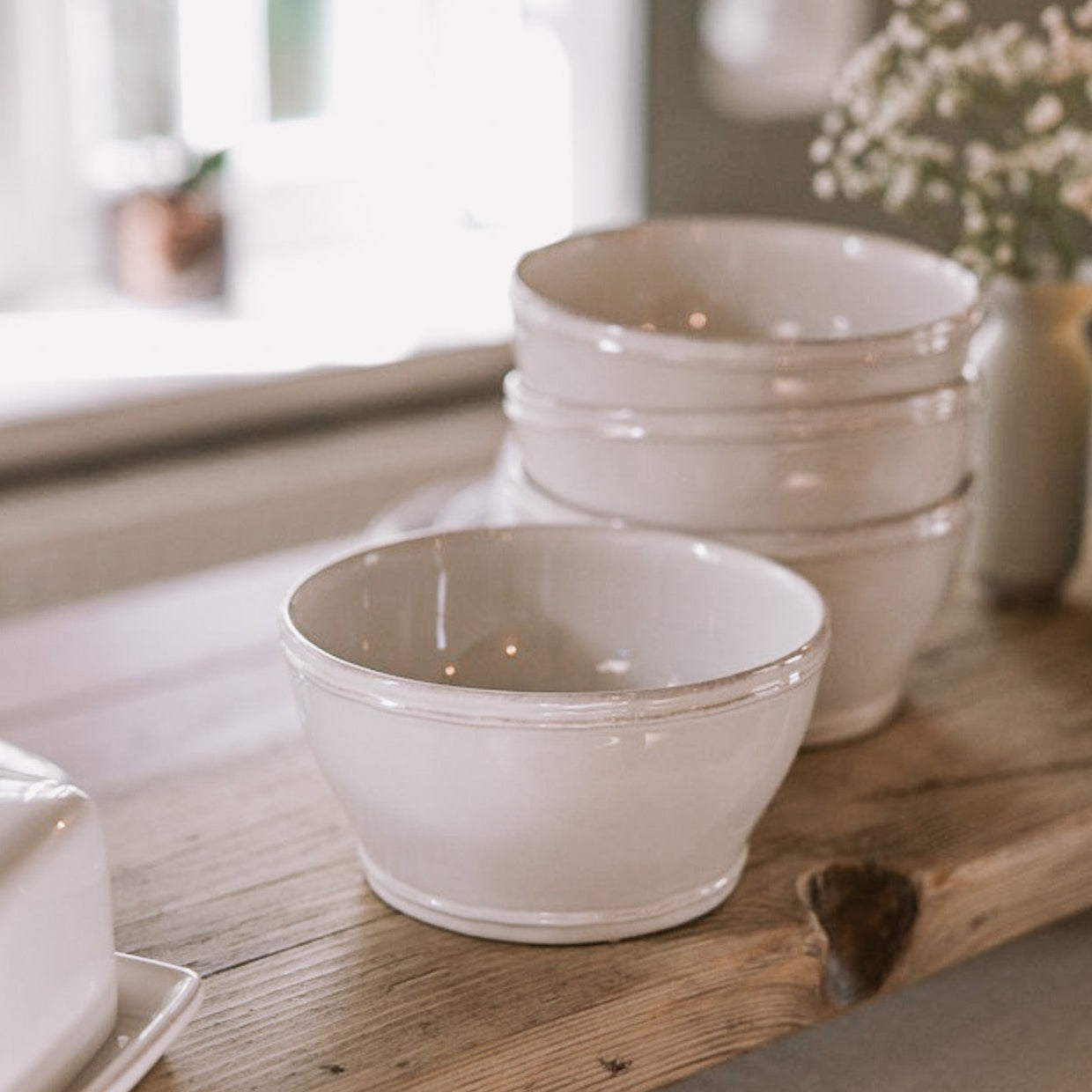 ceramic cereal bowls on wooden serving plank.