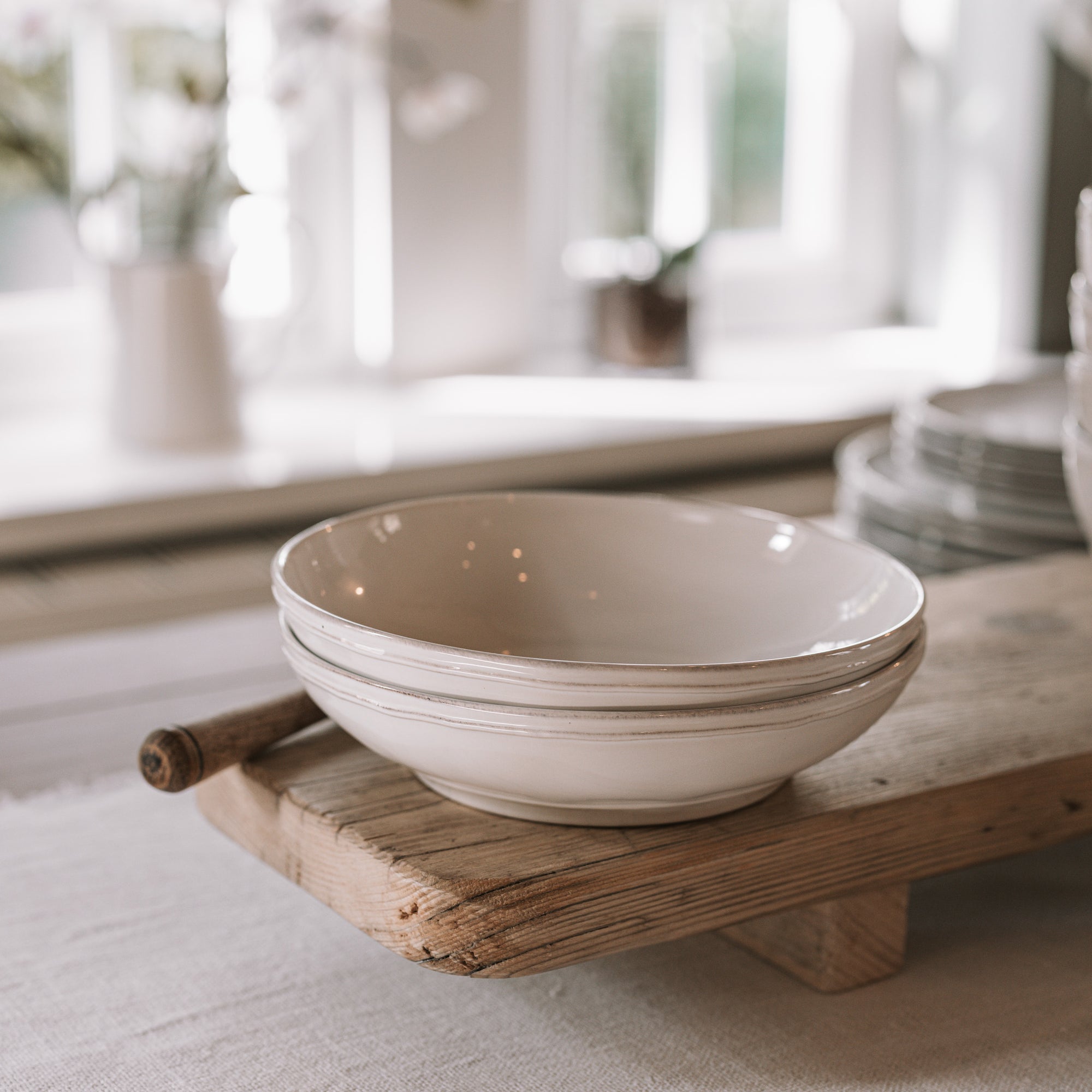 Ceramic pasta plate on wooden table.