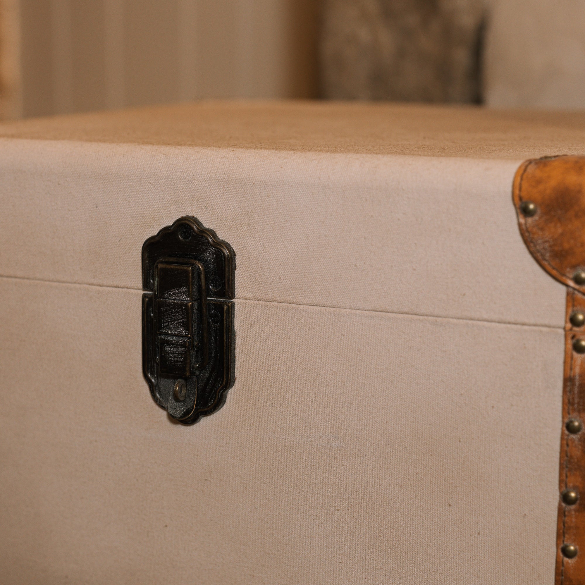 detailed shot of the metal clasp on linen storage trunks.