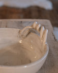 Detailed shot of white ceramic bowl with twisted handles. 