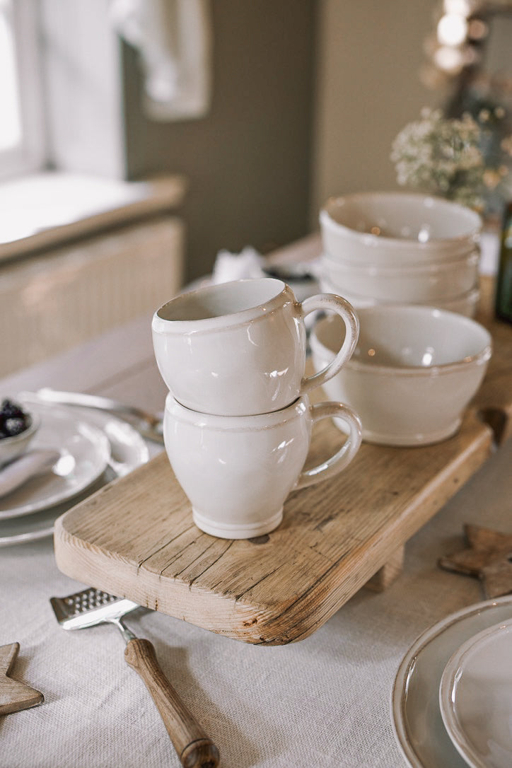 Set of two White Mugs on wooden serving plank.